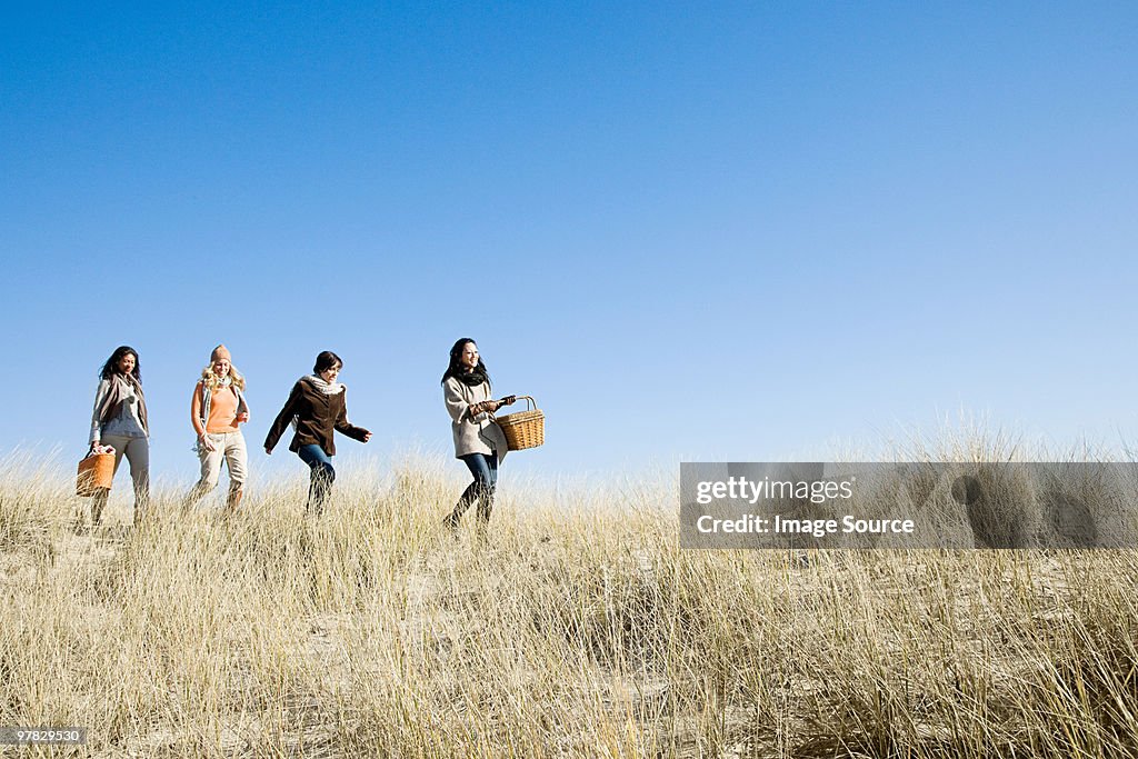 Female friends walking in marram grass