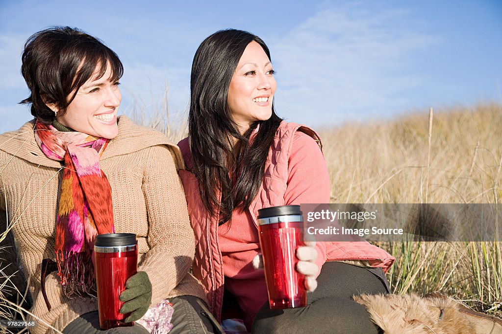 Female friends with drink flasks