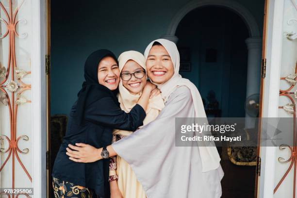sibling having good time together - ramadan indonesia stock pictures, royalty-free photos & images