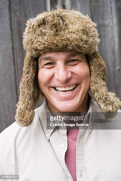mature man wearing fur hat - deerstalker hat stock pictures, royalty-free photos & images