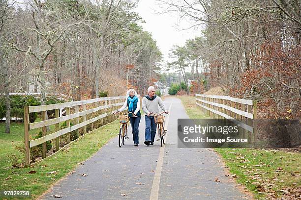 mature couple with bicycles - cape cod stock pictures, royalty-free photos & images