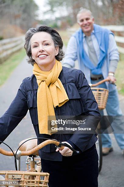 mature couple with bicycles - mature couple winter outdoors stock pictures, royalty-free photos & images