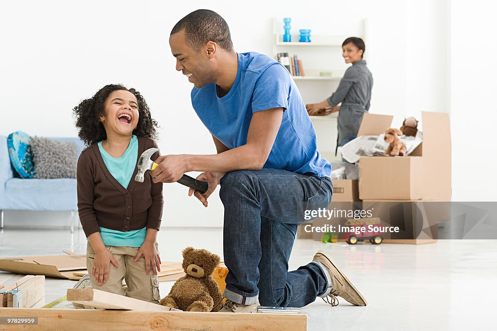 Girl and father building furniture