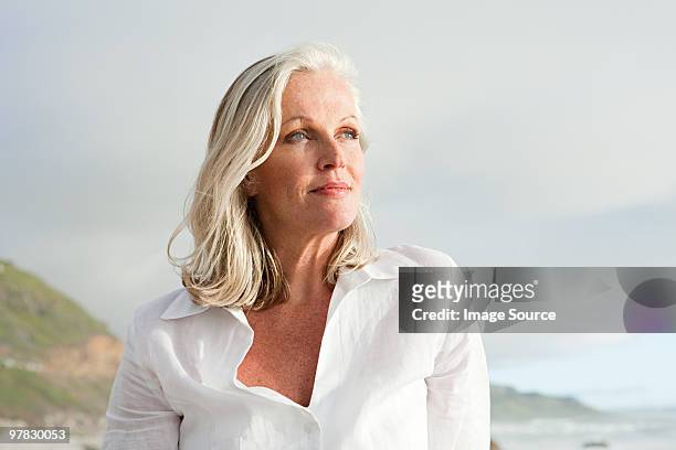 mature woman at coast - vrouw 50 jaar stockfoto's en -beelden