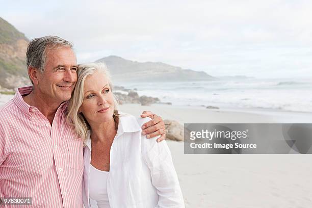 mature couple at the beach - baby boomer stock pictures, royalty-free photos & images