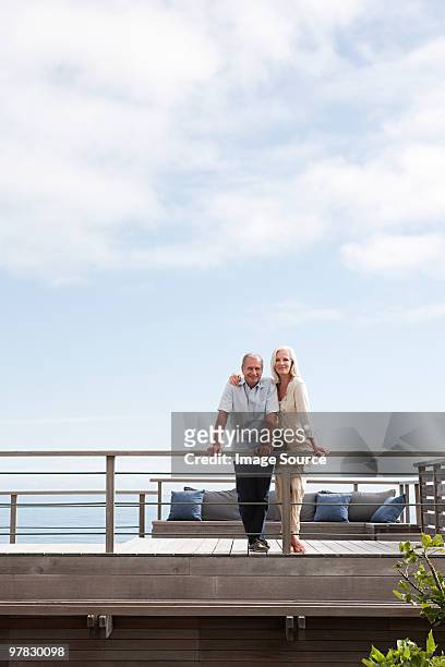 couple on balcony of beach house - beach house balcony stock pictures, royalty-free photos & images