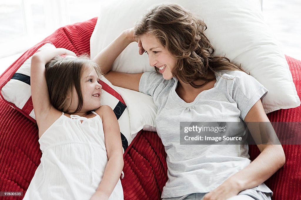 Mother and daughter lying down