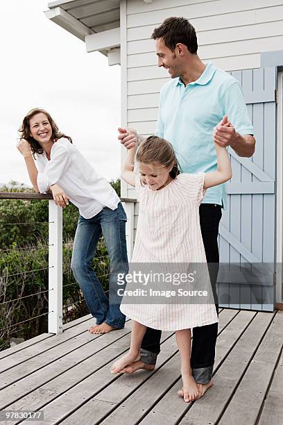 family outside holiday home - beach house balcony stock pictures, royalty-free photos & images