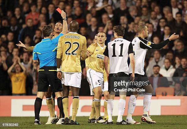 Fabio Cannavaro of Juventus is shown the red card by referee Bjorn Kuipers during the UEFA Europa League Round of 16 second leg match between Fulham...