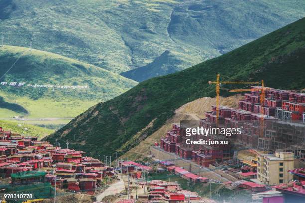 outside the building of china's sida wuming buddhist academy in sichuan province - sida stock pictures, royalty-free photos & images