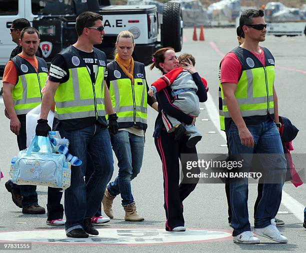 Spanish police officers take a group of Spanish detainees accused of drug trafficking to board an aircraft on their way back to Spain, at La Guaira...