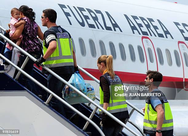 Spanish police officers escort a group of Spanish detainees accused of drug trafficking to board an aircraft on their way back to Spain, at La Guaira...
