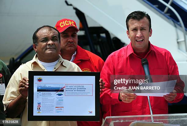 Venezuelan Interior and Justice Minister Tarek El Aissami shows to the press a reproduction of a digital page of El Mundo, before the deportation of...