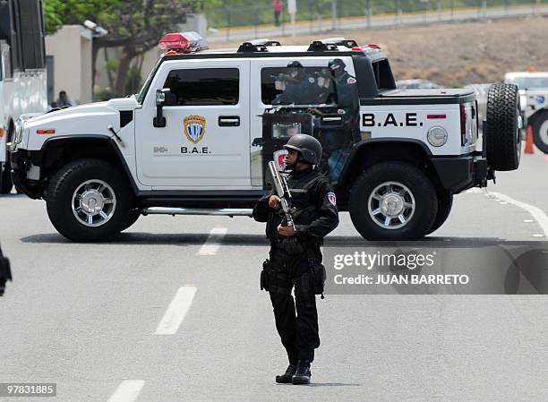 Venezuelan special police block a road before the deportation of a group of Spanish detainees accused of drug trafficking back to Spain, at La Guaira...