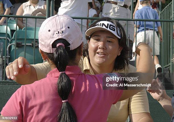 Winner Pat Hurst hugs runner-up Jeong Jang on the 18th green after the final round of the Safeway Classic at Columbia-Edgewater Country Club in...