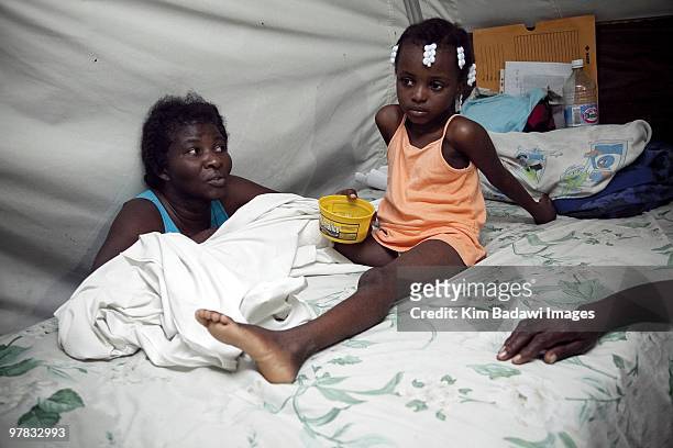 Mauelle Ester and her mother, earthquake survivors, at the Red Cross medical observation tent inside General Hospital on February 8, 2010 in...