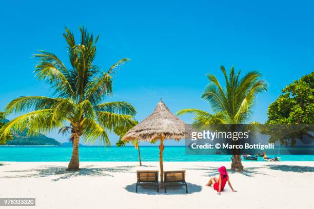 woman relaxing on idyllic tropical beach - wonderlust stockfoto's en -beelden