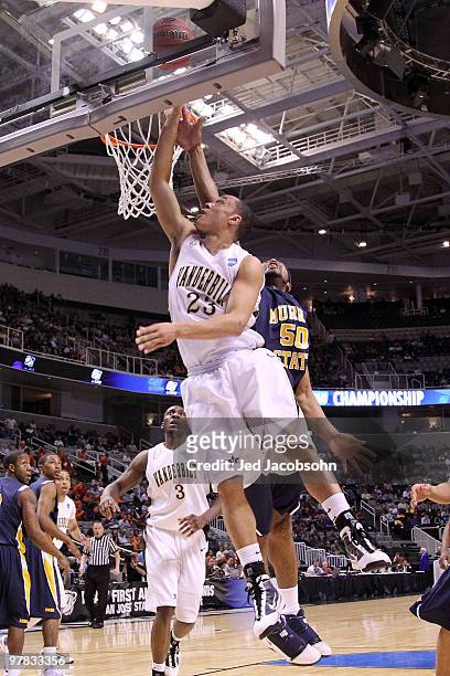 Guard John Jenkins of the Vanderbilt Commodores goes up for a shot as center Georges Fotso of the Murray State Racers defends during the first round...