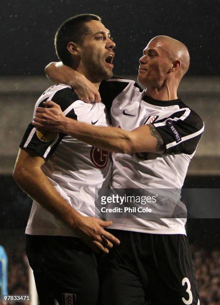 Clint Dempsey of Fulham celebrates scoring with Paul Konchesky during the UEFA Europa League Round of 16 second leg match between Fulham and Juventus...