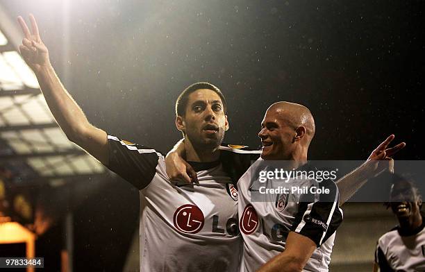 Clint Dempsey of Fulham celebrates scoring with Paul Konchesky during the UEFA Europa League Round of 16 second leg match between Fulham and Juventus...