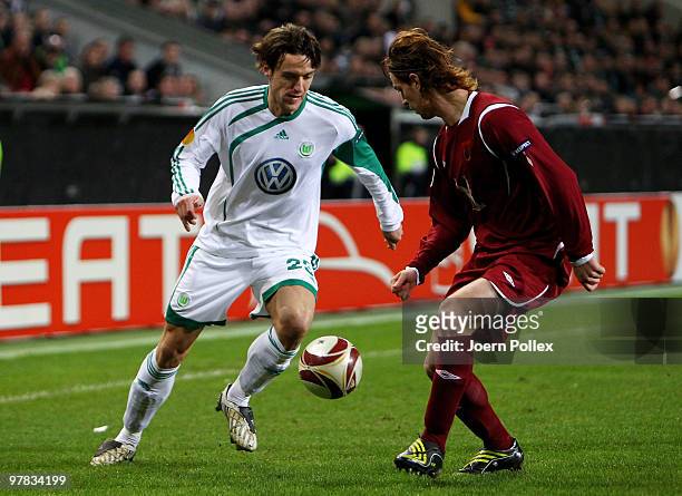 Christian Gentner of Wolfsburg and Cristian Ansaldi of Kazan compete for the ball during the UEFA Europa League round of 16 second leg match between...