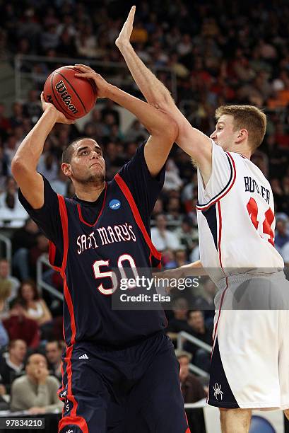 Omar Samhan of the Saint Mary's Gaels takes a shot as Ryan Butler of the Richmond Spiders defends during the first round of the 2010 NCAA men's...