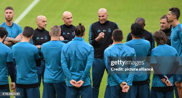 April 2018, Germany, Munich: Zinedine Zidane , coach of Real Madrid, David Bettoni, assistant coach, and Antonio Pintus, fitness coach of Real...