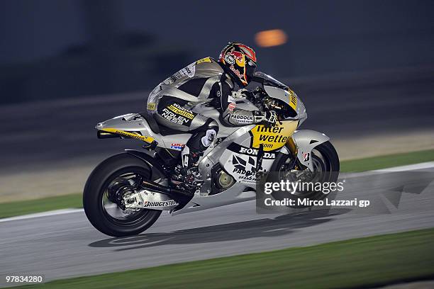 Hiroshi Aoyama of Japan and Interwetten MotoGP Team lifts the front wheel during the second day of testing at Losail Circuit on March 18, 2010 in...