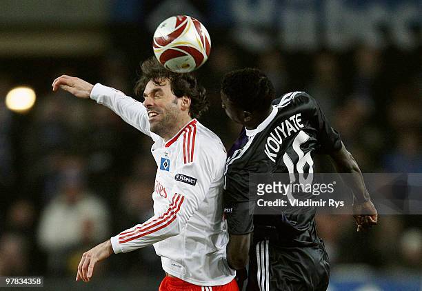 Ruud van Nistelrooy of Hamburg and Cheikhou Kouyate of Anderlecht go up for a header during the UEFA Europa League round of 16 second leg match...