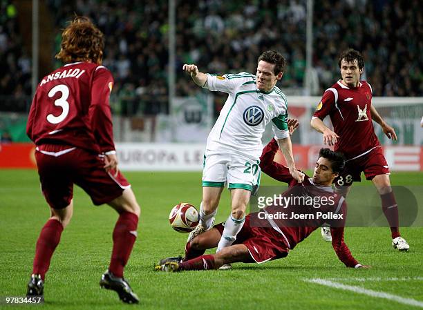 Sascha Riether of Wolfsburg and Christian Noboa , Alan Kasaev and Cristian Ansaldi of Kazan compete for the ball during the UEFA Europa League round...