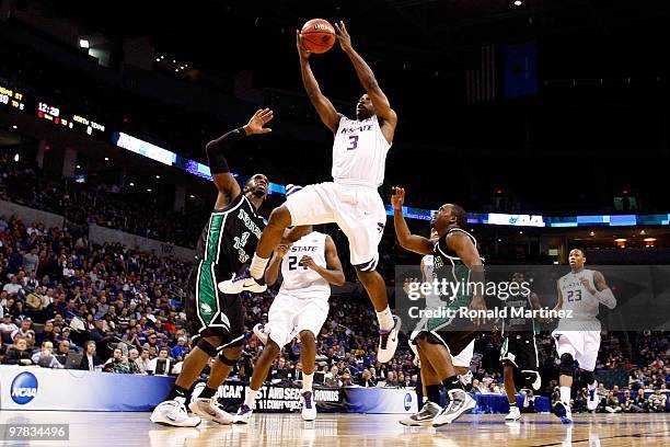 Martavious Irving of the Kansas State Wildcats drives for a shot attempt against George Odufuwa of the North Texas Mean Green during the first round...