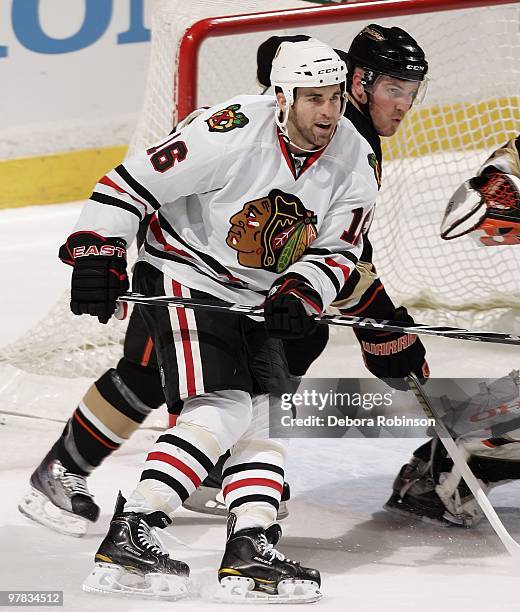 Andrew Ladd of the Chicago Blackhawks defends outside the crease against James Wisniewski of the Anaheim Ducks during the game on March 17, 2010 at...