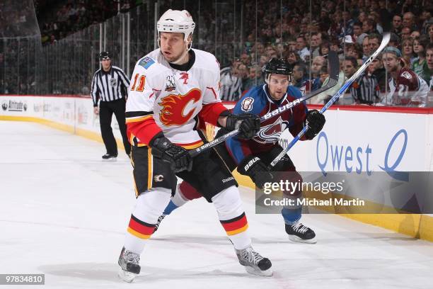 Niklas Hagman of the Calgary Flames skates against John-Michael Liles of the Colorado Avalanche at the Pepsi Center on March 17, 2010 in Denver,...