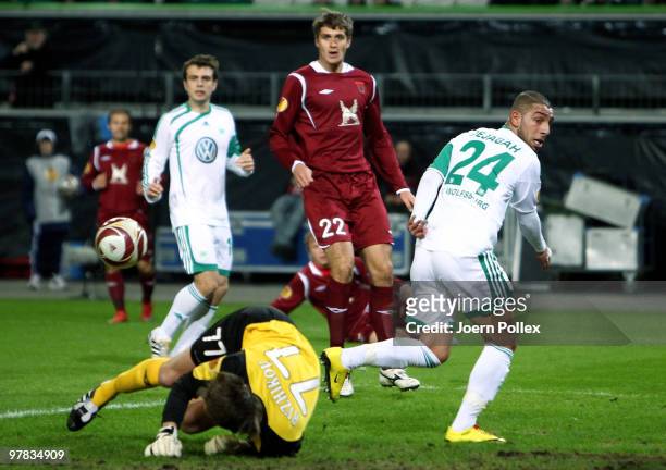 Ashkan Dejagah of Wolfsburg and goal keeper Sergei Ryzhikov of Kazan compete for the ball during the UEFA Europa League round of 16 second leg match...