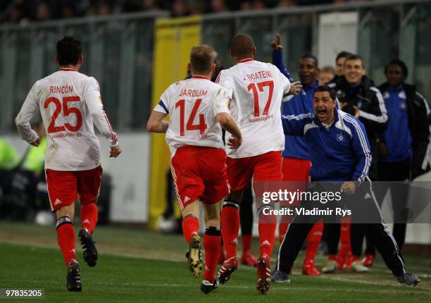 Jerome Boateng of Hamburg celebrates with his team mates after scoring his team's first goal during the UEFA Europa League round of 16 second leg...