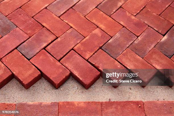 brick herriingbone pattern installation - sidewalk stock pictures, royalty-free photos & images