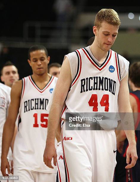 Ryan Butler and Francis-Cedric Martel of the Richmond Spiders walks off the court after they lost to the Saint Mary's Gaels during the first round of...