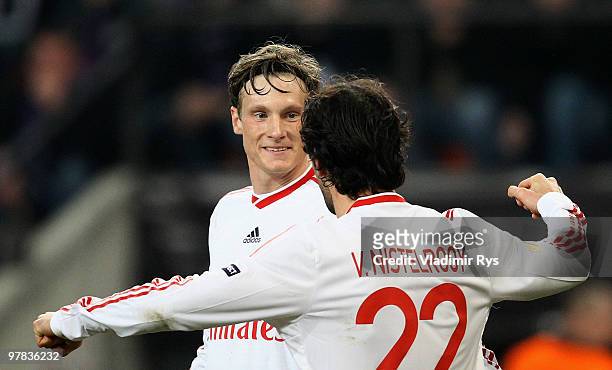 Marcell Jansen of Hamburg is celebrated by his team mate Ruud van Nistelrooy after scoring his team's second goal during the UEFA Europa League round...