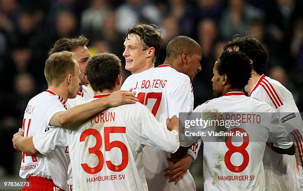 Marcell Jansen of Hamburg is celebrated by his team mates after scoring his team's second goal during the UEFA Europa League round of 16 second leg...