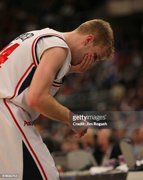 Ryan Butler of the Richmond Spiders reacts after he was hit in the face under the boards against the Saint Mary's Gaels during the first round of the...