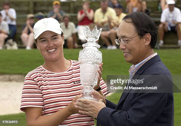 Sophie Gustafson receives the trophy from Dong-Jin Oh President & CEO Samsung Electronics America, Inc., Sunday, October 12, 2003 at the Samsung...