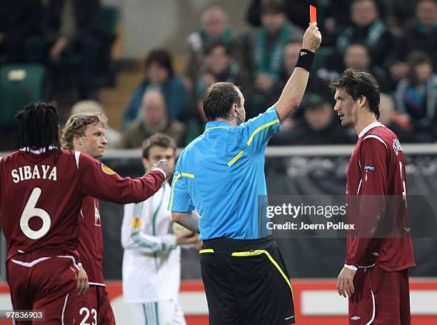 Cesar Navas of Kazan gets the red card of referee Jonas Eriksson during the UEFA Europa League round of 16 second leg match between VfL Wolfsburg and...