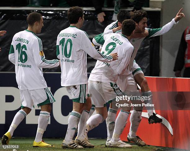 Christian Gentner of Wolfsburg celebrates with his team mates after scoring his team's second goal during the UEFA Europa League round of 16 second...