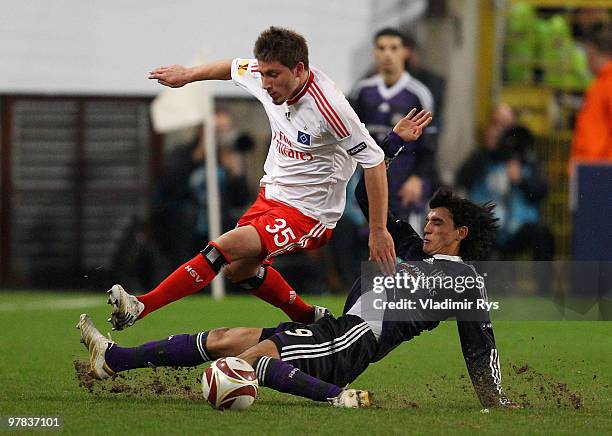 Matias Suarez of Anderlecht slides into Tunay Torun of Hamburg during the UEFA Europa League round of 16 second leg match between RSC Anderlecht and...