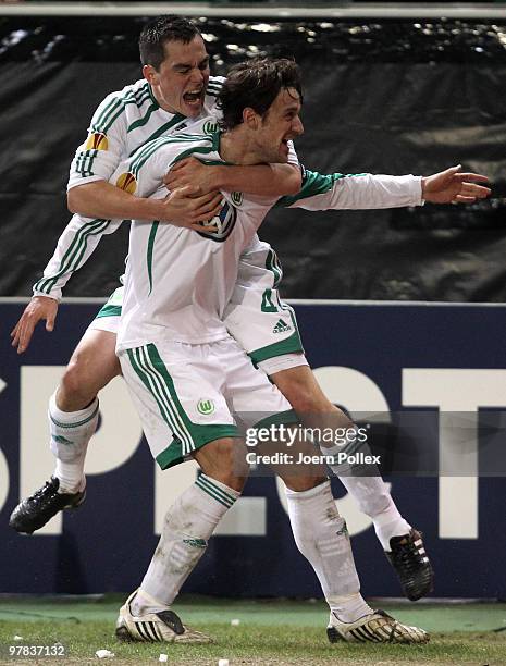 Christian Gentner of Wolfsburg celebrates with his team mates after scoring his team's second goal during the UEFA Europa League round of 16 second...