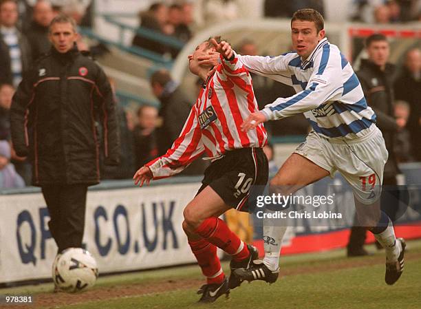 Christer Warren of Queens Park Ranges is tackles Paul Delvin of Sheffield United during the Nationwide First Division match between Queens Park...