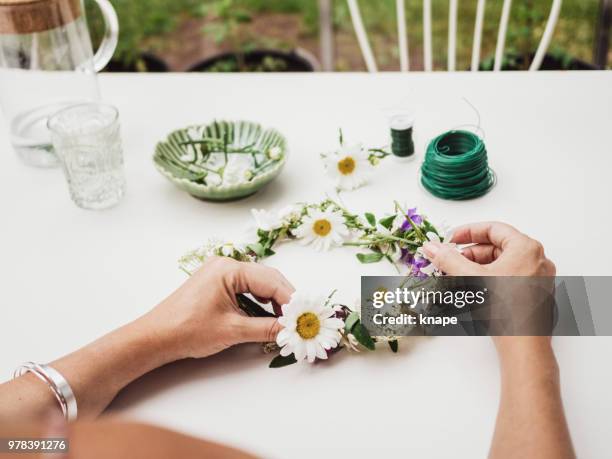 making tying midsummer midsommar wreath - wreath making stock pictures, royalty-free photos & images