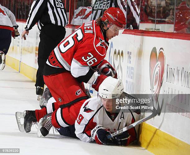 Jussi Jokinen of the Carolina Hurricanes pins Nicklas Backstrom of the Washington Capitals against the boards during their NHL game on March 18, 2010...