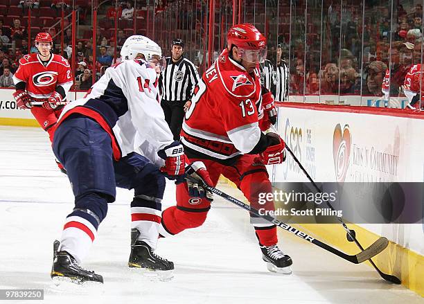 Ray Whitney of the Carolina Hurricanes battles along the boards with Tomas Fleischmann of the Washington Capitals during their NHL game on March 18,...