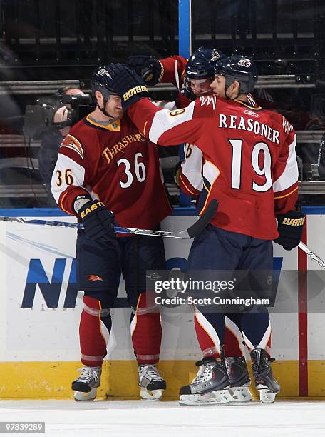 Eric Boulton and Marty Reasoner of the Atlanta Thrashers congratulate Evgeny Artyukhin after scoring a first period goal against the Ottawa Senators...